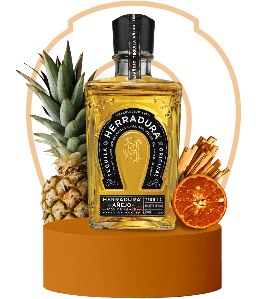 An image of a bottle of Herradura Anejo on an orange platform surrounded by flavor notes of pineapple, cinnamon, and dried citrus. wp-image-58 bottle from Casa Herradura