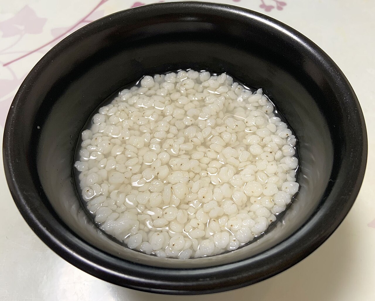 A bowl of cooked whole sorghum grains